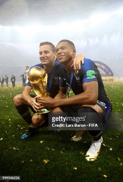 Florian Thauvin and Kylian Mbappe of France celebrate victory with the World Cup trophy following the 2018 FIFA World Cup Final between France and...