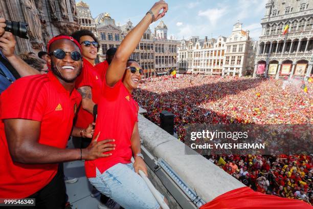 Belgium's players Michy Batshuayi, Axel Witsel and Youri Tielemans celebrate at the balcony in front of more than 8000 supporters at the Grand-Place,...