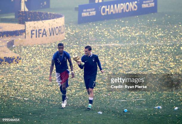 Presnel Kimpembe and Antoine Griezmann of France of France celebrate victory following the 2018 FIFA World Cup Final between France and Croatia at...