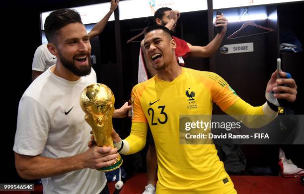 Olivier Giroud of France and Alphonse Areola of France celebrate with the World Cup Trophy in the dressing room following their sides victory in the...