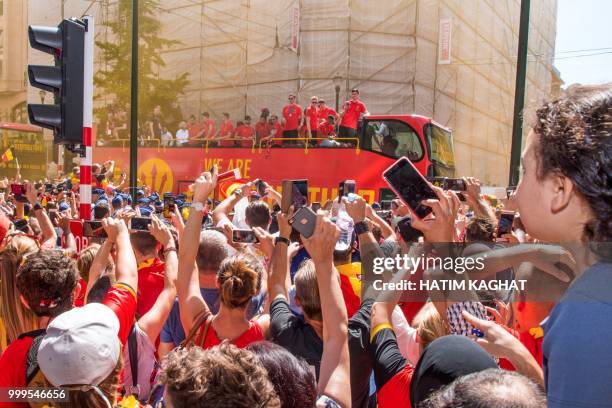 Supporters cheer as an open bus with the Red Devils pass by on their way to the Grand Place, Grote Markt in the city centre of Brussels, as Belgian...