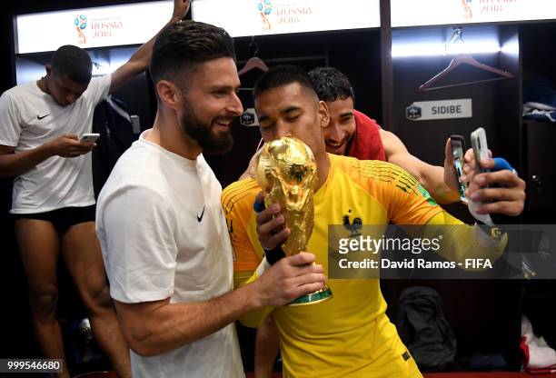 Olivier Giroud of France and Alphonse Areola of France celebrate with the World Cup Trophy in the dressing room following their sides victory in the...