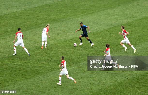 Kylian Mbappe of France is challenged by Domagoj Vida, Dejan Lovren, Ivan Rakitic and Luka Modric during the 2018 FIFA World Cup Final between France...