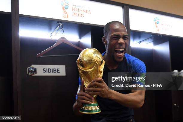 Djibril Sidibe of France celebrates in the dressing room with the World Cup Trophy following his sides victory in the 2018 FIFA World Cup Final...