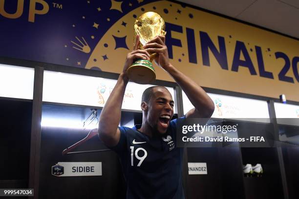 Djibril Sidibe of France celebrates in the dressing room with the World Cup Trophy following his sides victory in the 2018 FIFA World Cup Final...