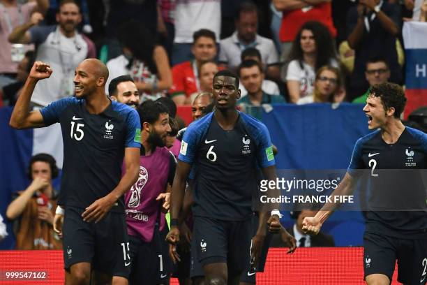 France's midfielder Steven N'Zonzi , France's midfielder Paul Pogba , France's defender Benjamin Pavard and teammates celebrate their fourth goal...