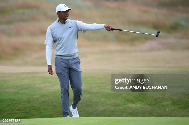 Golfer Tiger Woods gestures on the 2nd green during the first practice session at The 147th Open Championship at Carnoustie, Scotland on July 15,...
