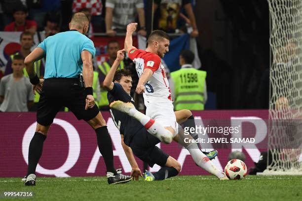 Croatia's forward Ante Rebic attempts a shot as he is marked by France's defender Benjamin Pavard during the Russia 2018 World Cup final football...