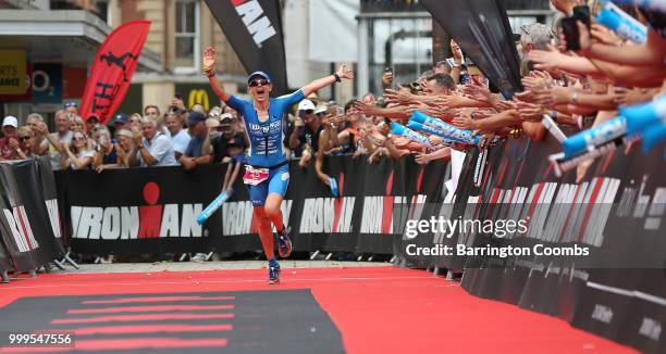 Lucy Gossage starts to celebrate winning the Iron Man in Bolton during the Iron Man Triathlon in Bolton on July 15, 2018 in Bolton, England.