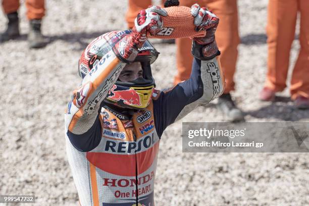 Marc Marquez of Spain and Repsol Honda Team celebrates Dani Pedrosa of Spain with his cap at the end of the MotoGP race during the MotoGp of Germany...