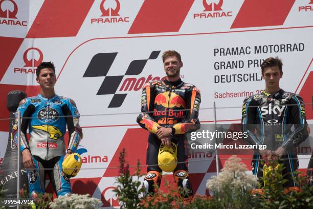 Joan Mir of Spain and EG 0,0 Marc VDS, Brad Binder of South Africa and Red Bull KTM Ajo and Luca Marini of Italy and Sky Racing Team VR46 celebrate...