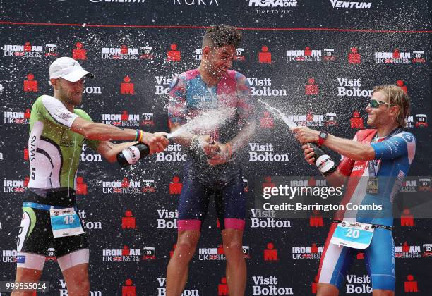 Great Britain's Joe Skipper poses for photographs on the podium after winning with Marc Duelsen of Germany and Fabian Rahn also of Germany during the...