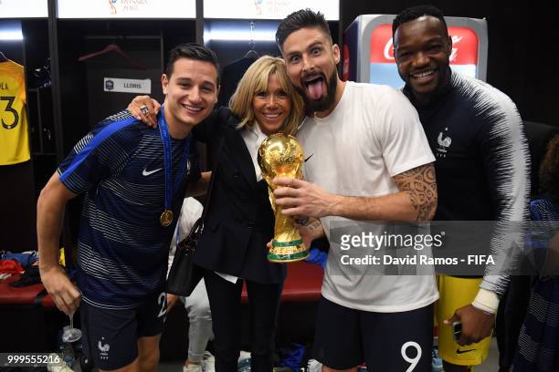 Wife of French President Emmanuel Macron, Brigitte Macron, Florian Thauvin, Olivier Giroud, and Steve Mandanda of France pose for a photo with the...