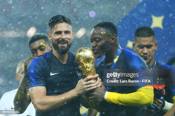 Olivier Giroud of France and team mate Steve Mandanda of France celebrate victory following the 2018 FIFA World Cup Final between France and Croatia...