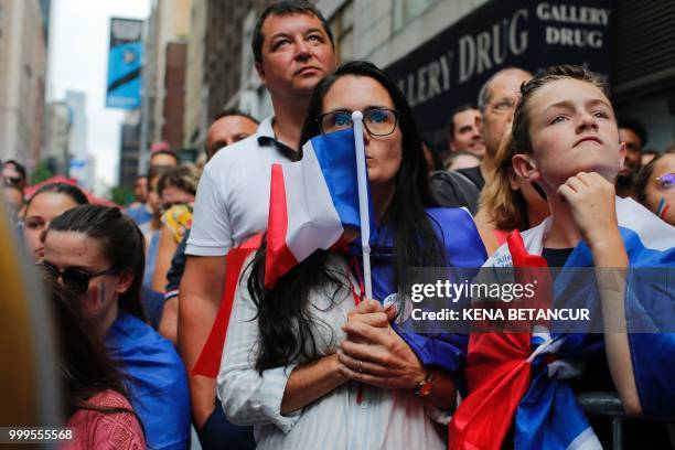 French fans react while they watch the World Cup final match between France vs Croatia on July 15, 2018 in New York. - The World Cup final between...