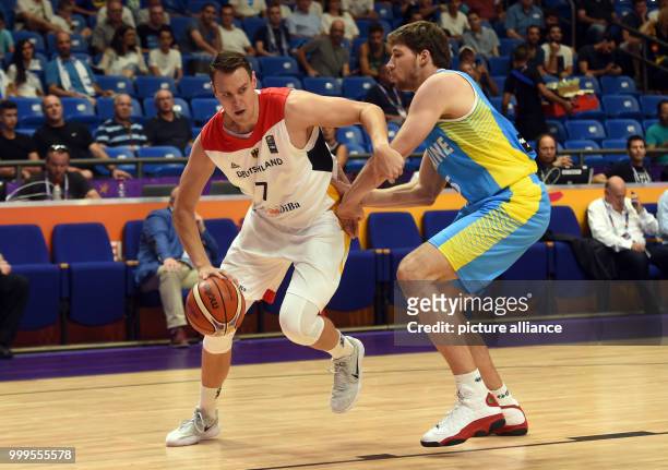 Johannes Voigtmann of Germany in action against Viacheslav Kravtsov of ukraine during the EuroBasket 2017 Group B game between the Germany and...