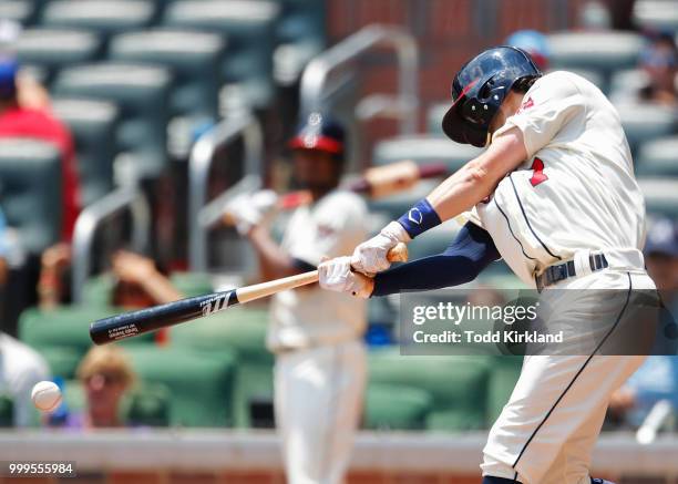 Dansby Swanson of the Atlanta Braves hits a double to bring in a run in the third inning of an MLB game against the Arizona Diamondbacks at SunTrust...