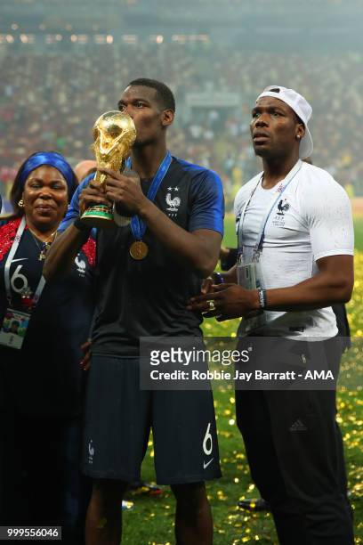Paul Pogba of France celebrates victory with mother Yeo and brother Mathias at the end of of the 2018 FIFA World Cup Russia Final between France and...