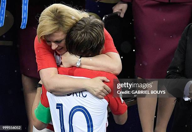 Croatian President Kolinda Grabar-Kitarovic comforts Croatia's midfielder Luka Modric during the trophy ceremony at the end of the Russia 2018 World...