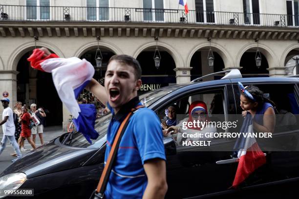 France supporters celebrate after France won the Russia 2018 World Cup final football match between France and Croatia, RUe de Rivoli in Paris on...