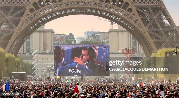 People celebrate in the fan zone the Russia 2018 World Cup final victory football match between France and Croatia, on the Champ de Mars in Paris on...