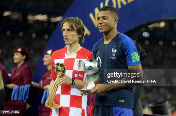 Luka Modric of Croatia and Kylian Mbappe of France pose respectively with their the adidas Golden Ball and with the FIFA Young Player award following...