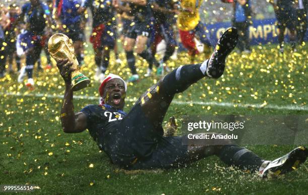 Benjamin Mendy holds up the trophy as he celebrates FIFA World Cup championship after the 2018 FIFA World Cup Russia final match between France and...