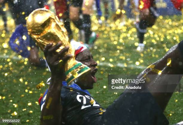 Benjamin Mendy holds up the trophy as he celebrates FIFA World Cup championship after the 2018 FIFA World Cup Russia final match between France and...