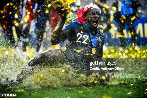 Benjamin Mendy of France celebrates the victory with the trophy during the World Cup Final match between France and Croatia at Luzhniki Stadium on...