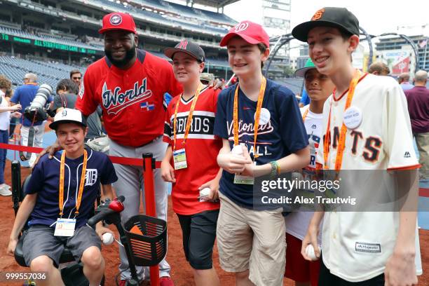 David Ortiz of the World Team poses for a photo with Make-A-Wish kids during batting practice prior to the SiriusXM All-Star Futures Game at...