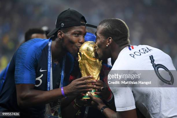 Paul Pogba of France's brother, Florentin Pogba, and Mathias Pogba celebrate with the World Cup Trophy following France's victory in the 2018 FIFA...