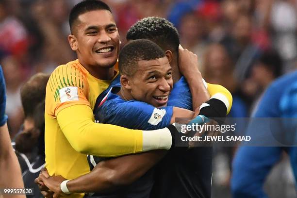 France's goalkeeper Alphonse Areola, France's forward Kylian Mbappe and France's defender Presnel Kimpembe celebrate at the end of the Russia 2018...
