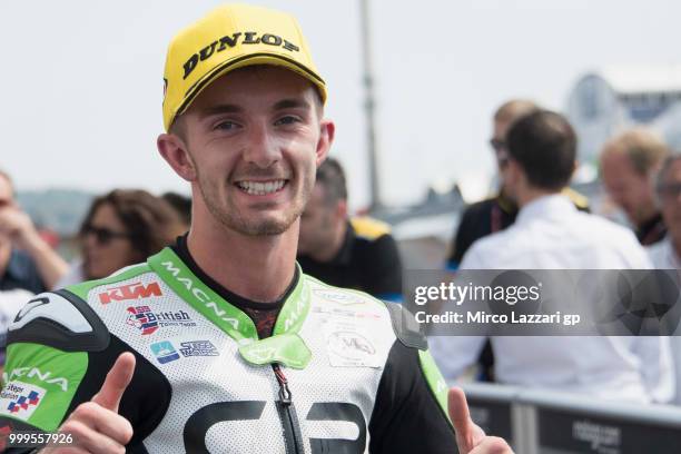 John McPhee of Great Britain and CIP Green Power celebrates the third place under the podium at the end of the Moto3 race during the MotoGp of...