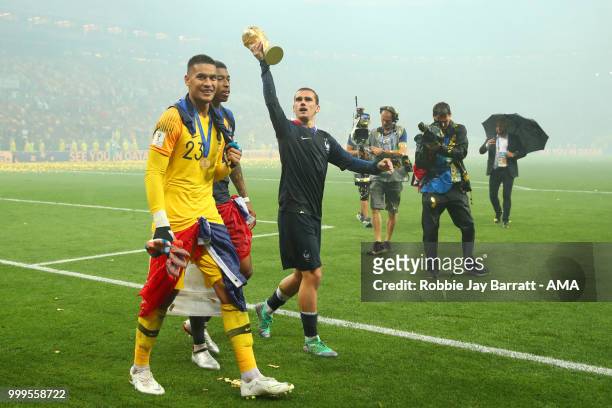 Antoine Griezmann of Franceand Alphonse Areola of France celebrate with the trophy at the end of of the 2018 FIFA World Cup Russia Final between...