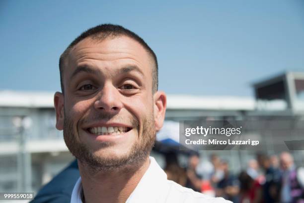 Sandro Cortese of Germany smiles on the grid during the Moto3 race during the MotoGp of Germany - Race at Sachsenring Circuit on July 15, 2018 in...