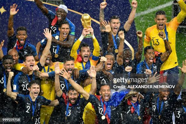 France's goalkeeper Hugo Lloris holds the trophy as he celebrates with teammates during the trophy ceremony after winning the Russia 2018 World Cup...