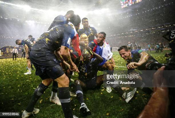 French players hold up the trophy as they celebrate FIFA World Cup championship after the 2018 FIFA World Cup Russia final match between France and...
