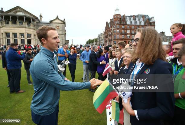 Open Champion Jordan Spieth of United States of America hands out participating medals to junior players during the Junior Open Championship opening...
