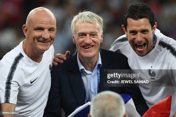 France's coach Didier Deschamps poses for a picture with assistant coach Guy Stephan and goalkeeping coach Franck Raviot after the Russia 2018 World...