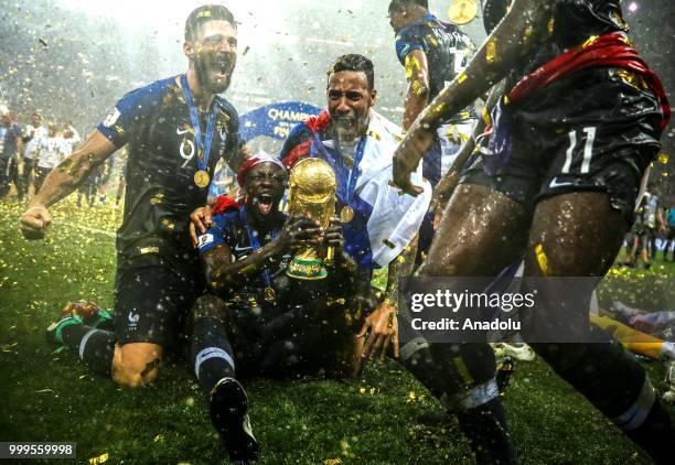 French players hold up the trophy as they celebrate FIFA World Cup championship after the 2018 FIFA World Cup Russia final match between France and...