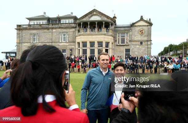 Open Champion Jordan Spieth of United States of America poses with junior players during the Junior Open Championship opening ceremony at The Old...