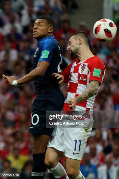 Kylian Mbappe of France heads for the ball with Marcelo Brozovic of Croatia during the 2018 FIFA World Cup Russia Final between France and Croatia at...
