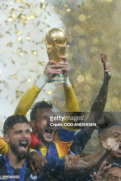 France's goalkeeper Hugo Lloris and his teammates celebrate with the World Cup trophy after the Russia 2018 World Cup final football match between...