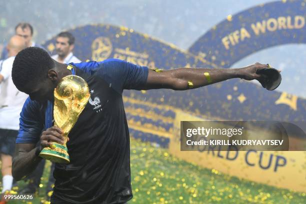 France's midfielder Paul Pogba celebrates with the trophy at the end of the Russia 2018 World Cup final football match between France and Croatia at...