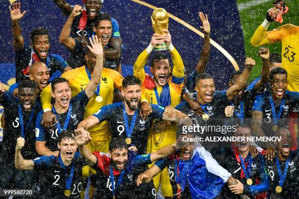France's goalkeeper Hugo Lloris holds the trophy as he celebrates with teammates during the trophy ceremony at the end of the Russia 2018 World Cup...