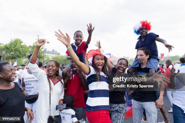 French fans gather on the Arc de Triomphe to celebrate the victory of France over Croatia 4-2 during the World Cup on July 15, 2018 in Paris, France.