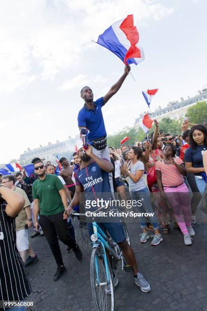 French fans gather on the Arc de Triomphe to celebrate the victory of France over Croatia 4-2 during the World Cup on July 15, 2018 in Paris, France.