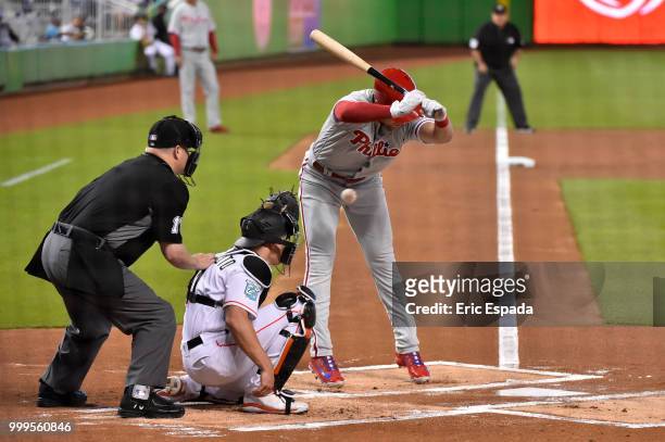 Rhys Hoskins of the Philadelphia Phillies jumps out of the way of a pitch during the first inning against the Miami Marlins at Marlins Park on July...