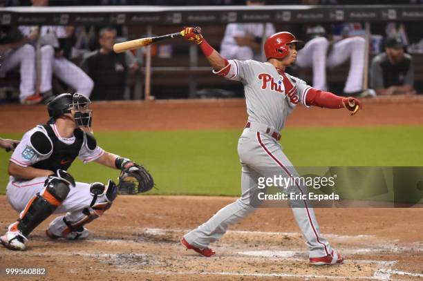 Cesar Hernandez of the Philadelphia Phillies hits a triple during the fourth inning against the Miami Marlins at Marlins Park on July 15, 2018 in...