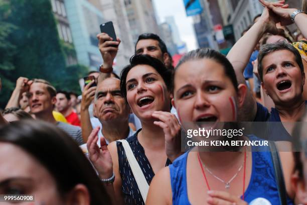 French fans react while they watch the World Cup final match between France vs Croatia on July 15, 2018 in New York. - The World Cup final between...
